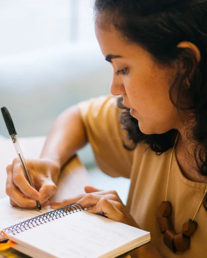 Beatriz Madruga escrevendo em seu caderno