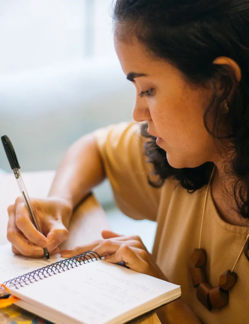 Beatriz Madruga escrevendo em seu caderno